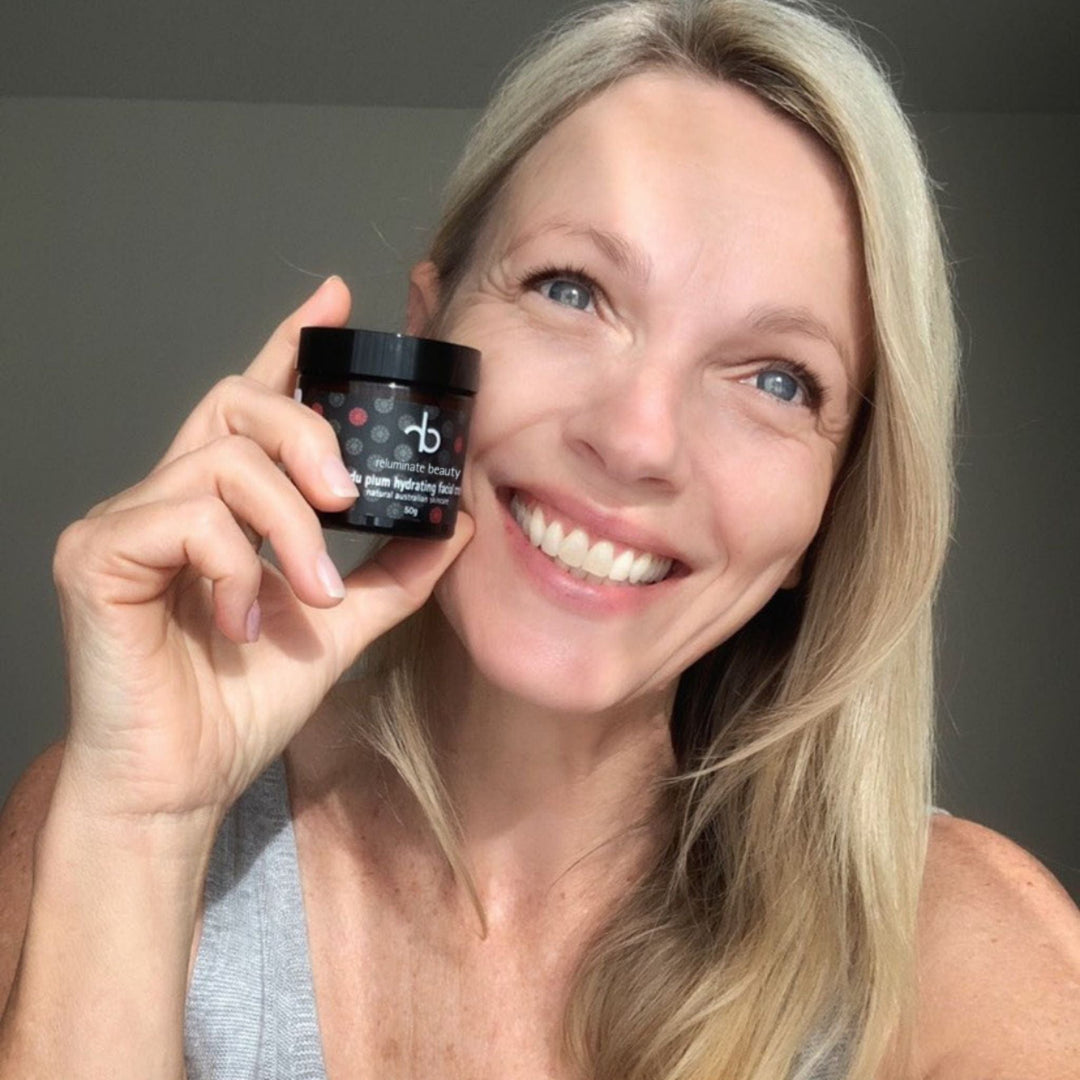 Happy beautiful mature woman holding Kakadu Plum Facial Cream